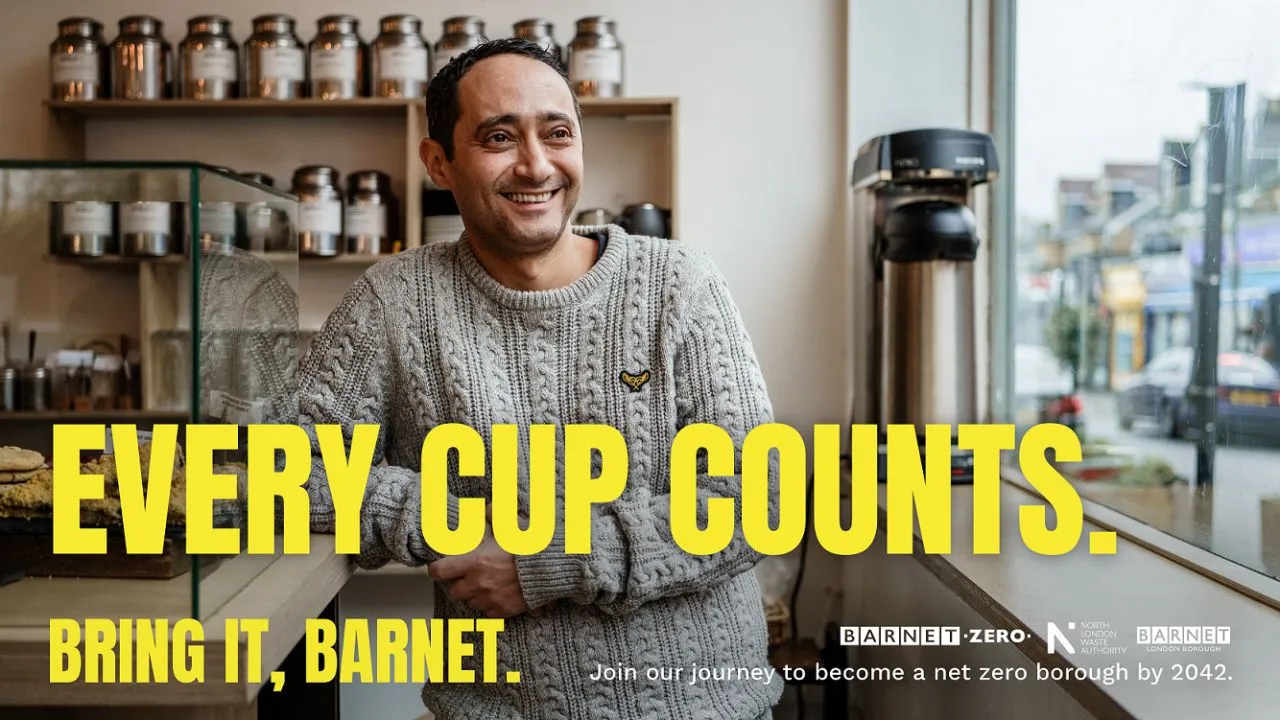Man smiling in a coffee shop looking out of the window