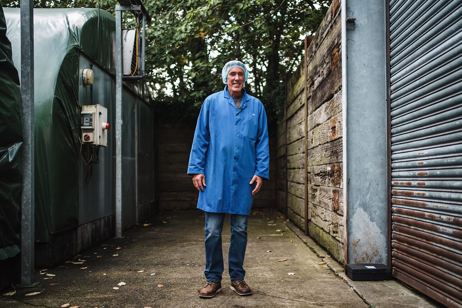 Man in protective headnet and blue overall