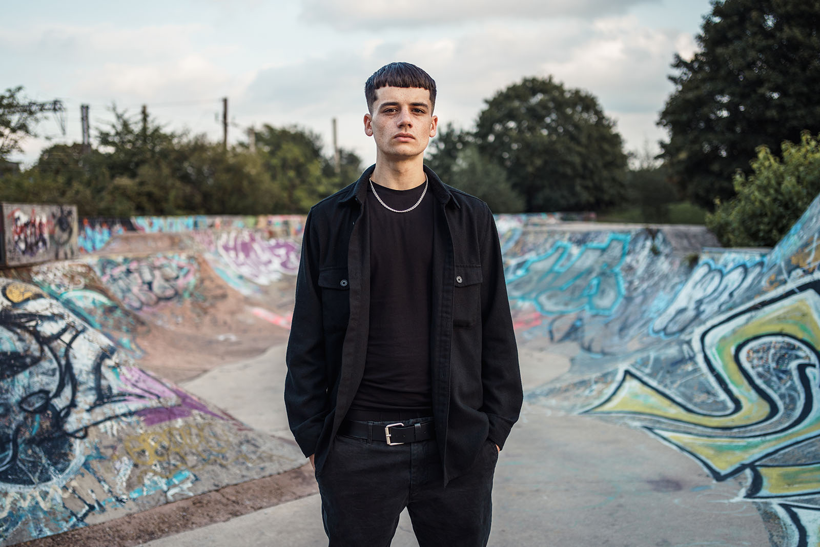 Image of young man in skateboard park