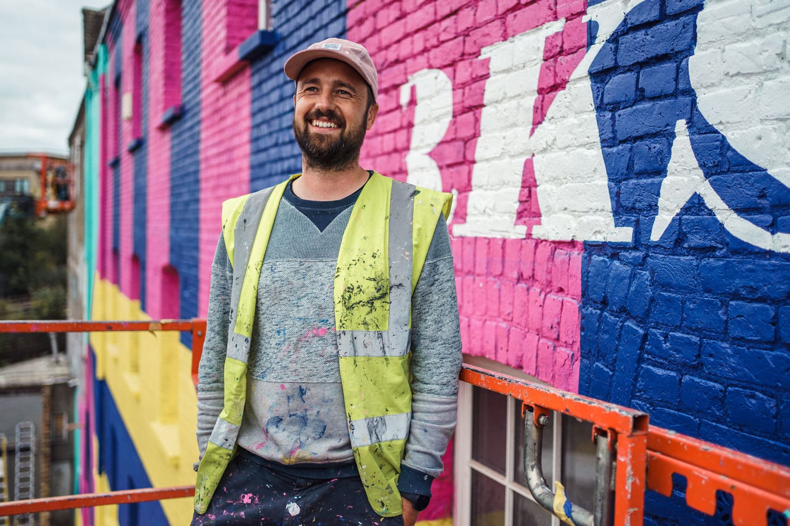 Urban Portrait of Luke James working on a mural in London