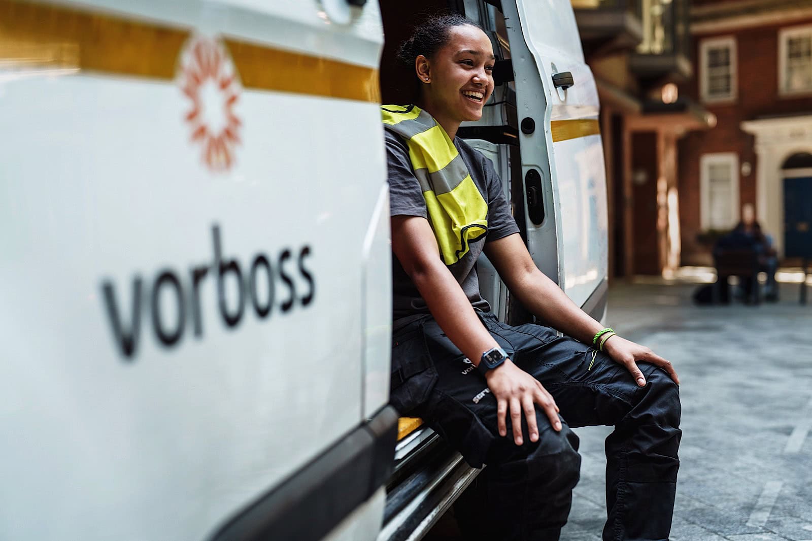 Commercial Image of woman sat in the side of a Vorboss van laughing