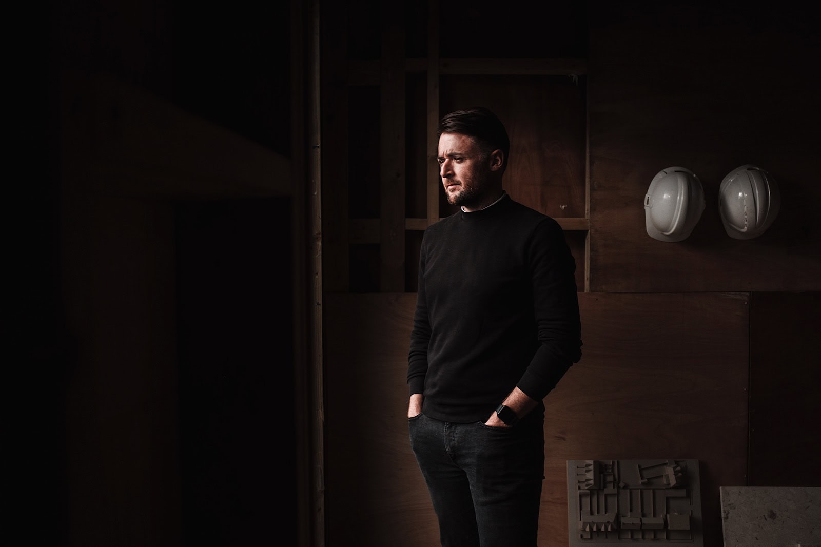 Commercial Portrait of man on building site looking out window