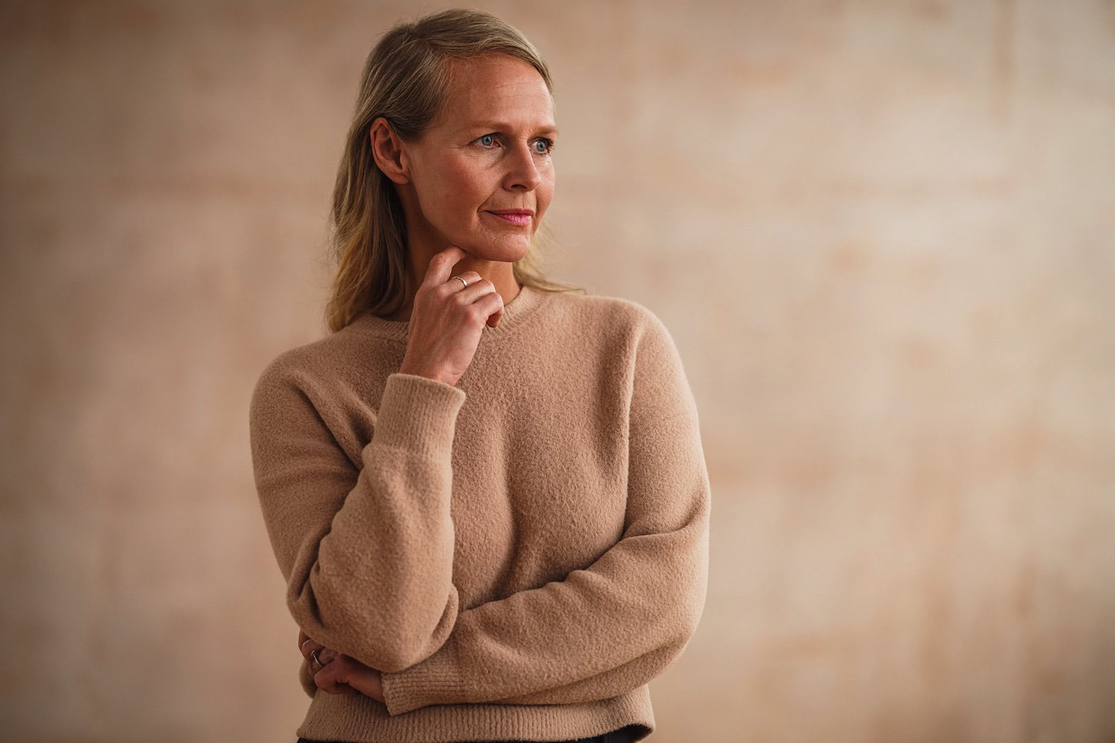 Woman looking pensive with arms crossed