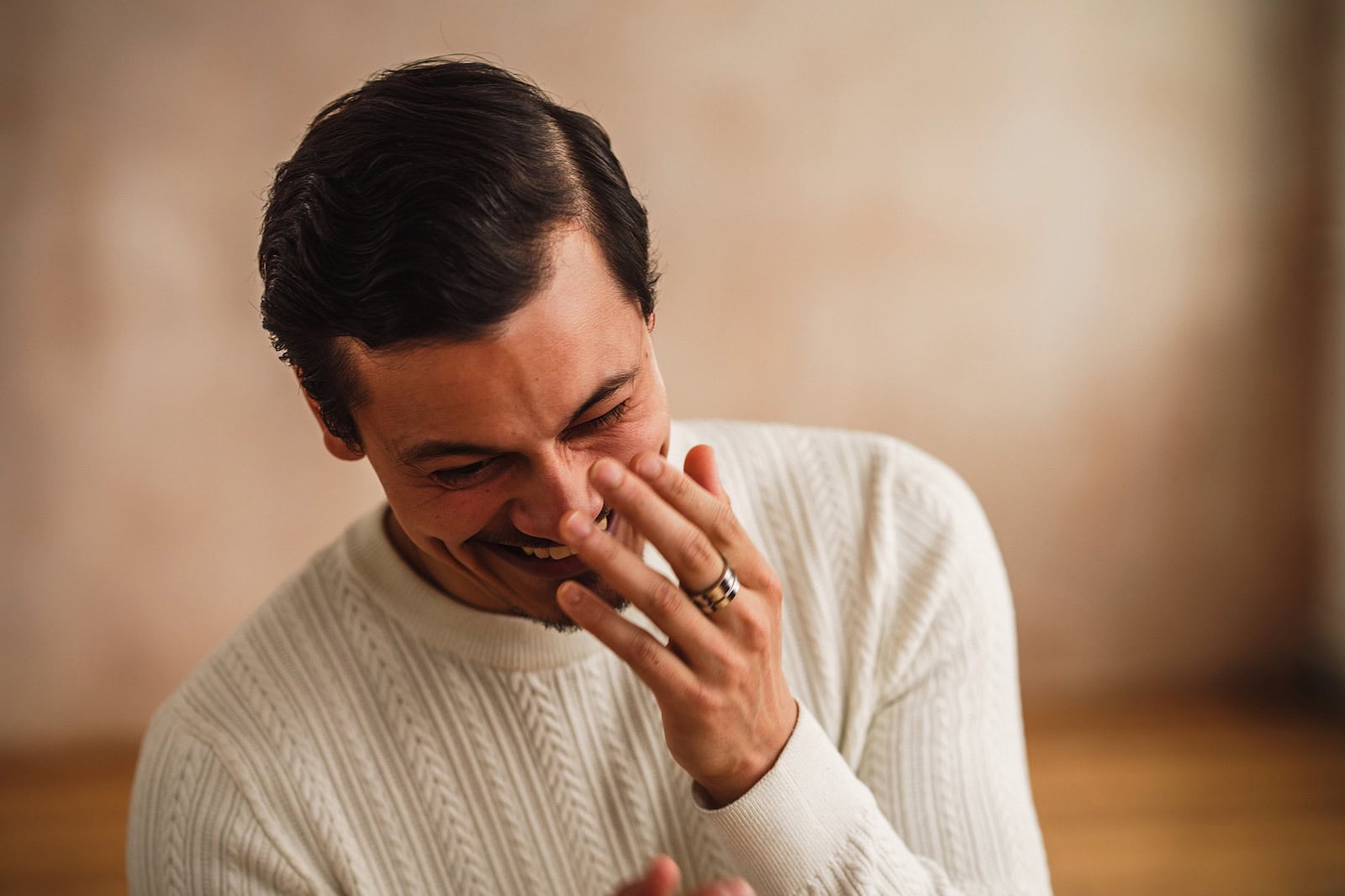 Man laughing during portrait shoot for unmind