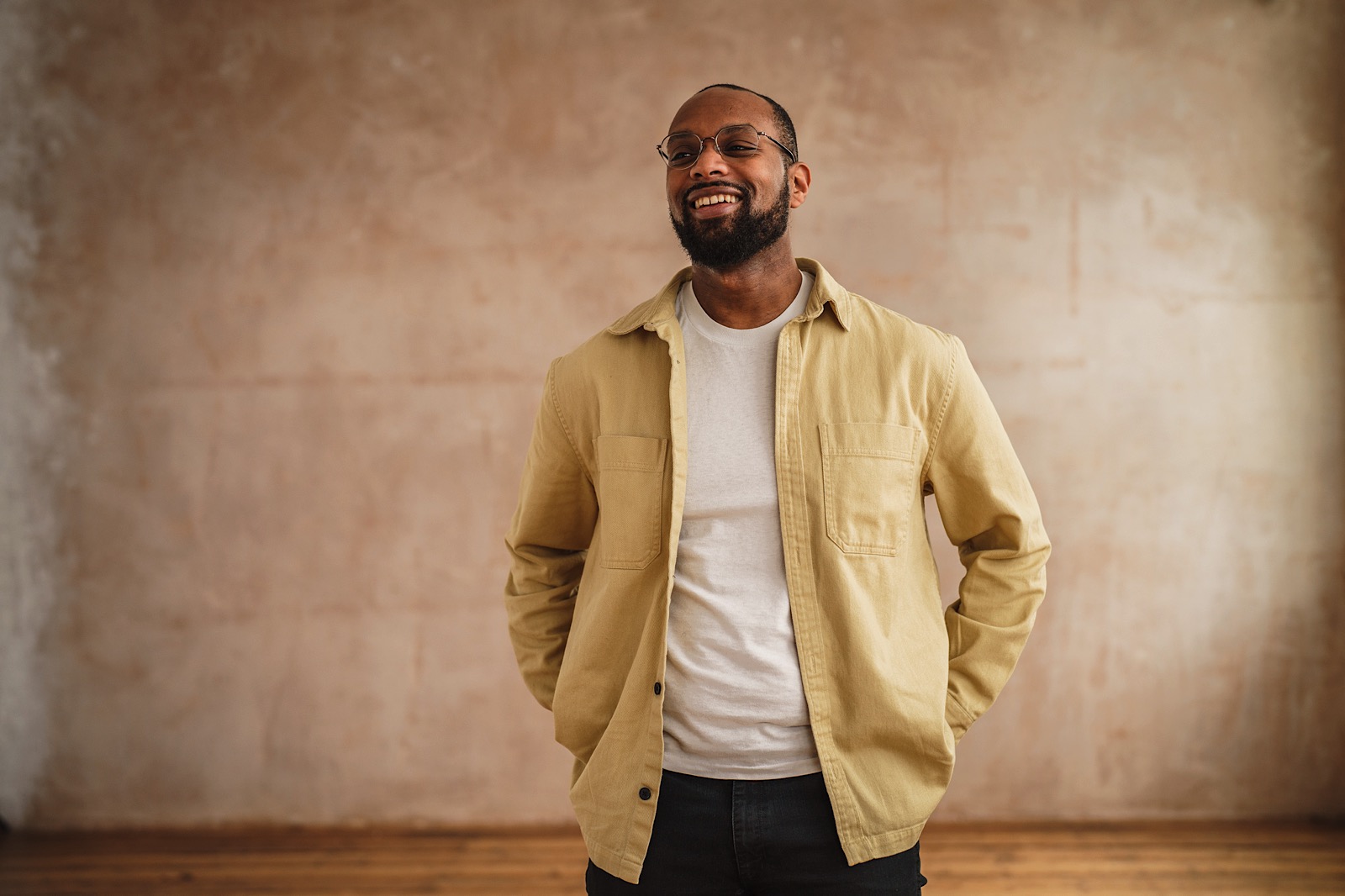 Man with hands in pockets during a studio portrait shoot for Unmind